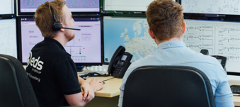 EDS employees looking at computer monitors