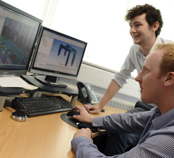 Two men looking at computer